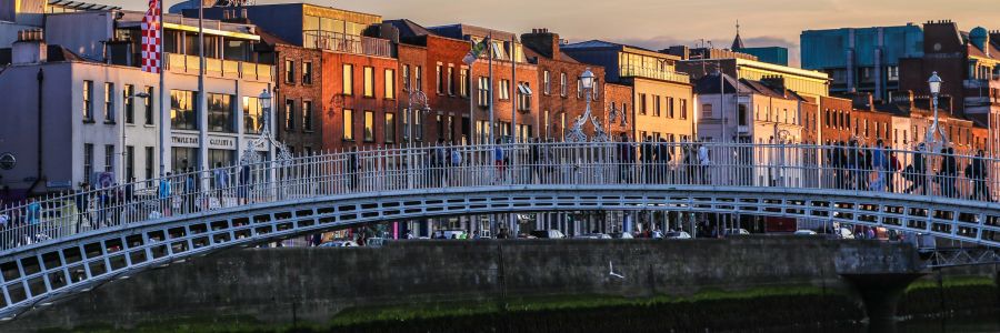 The Ha'Penny Bridge over the Liffey at sunset. Enjoy the iconic sights of Ireland with Discover Ireland Tours.
